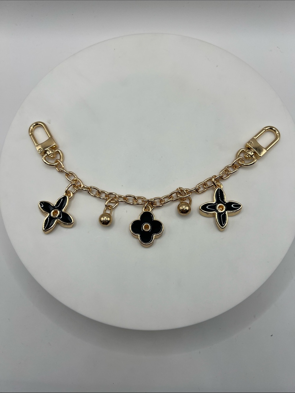 713. Gold and Black Enamel Flower Charm Bag Chain 8”